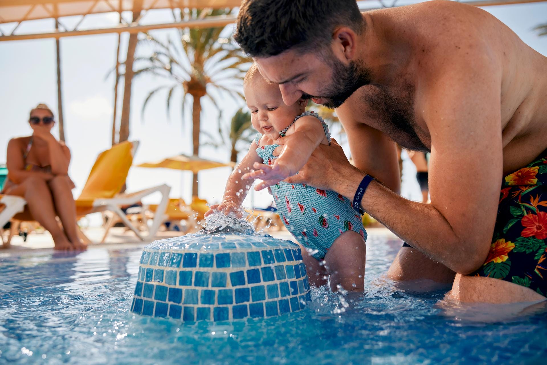 papa mit baby im pool